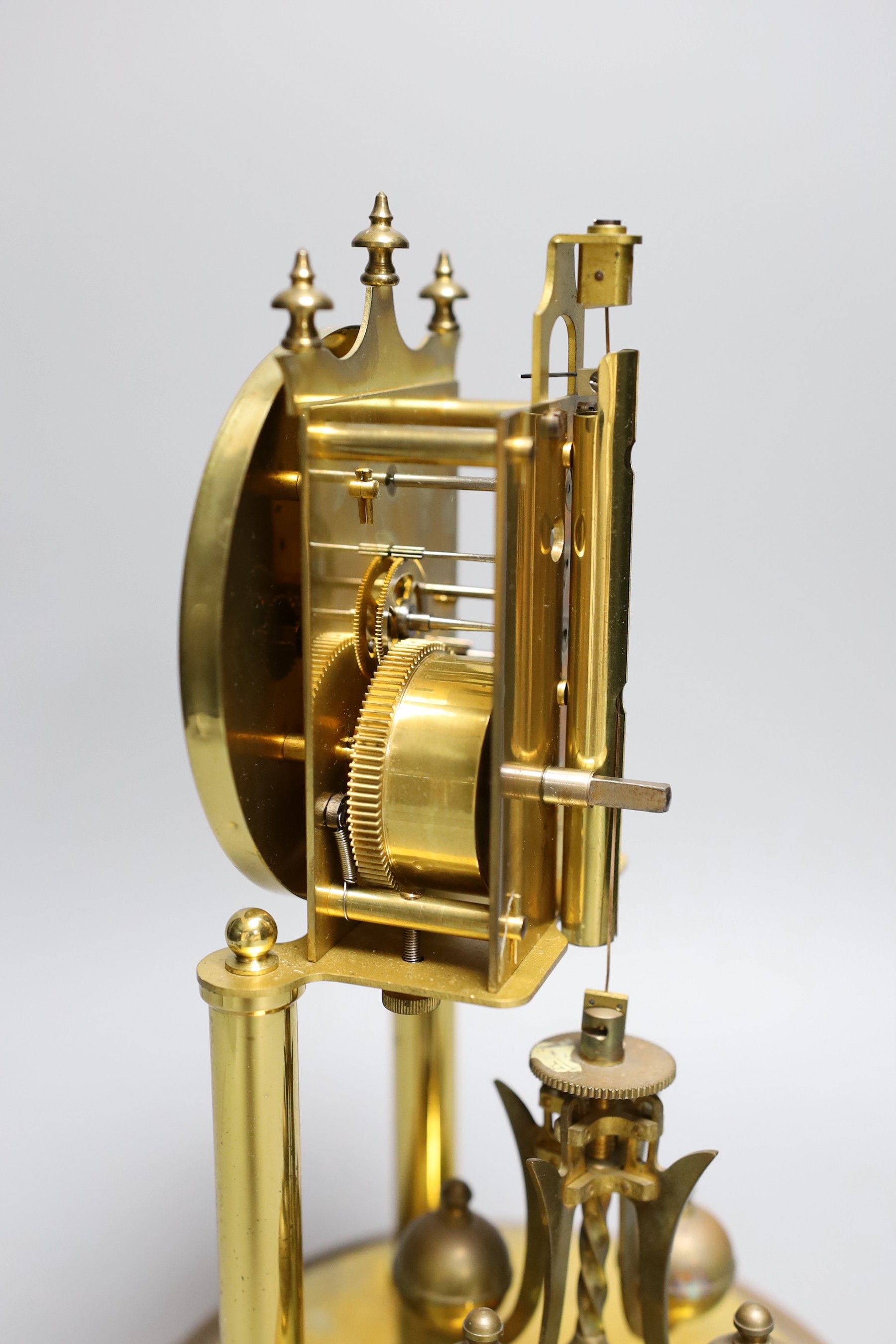 A German 400 day brass mantel timepiece, under a glass dome, 30cm total height